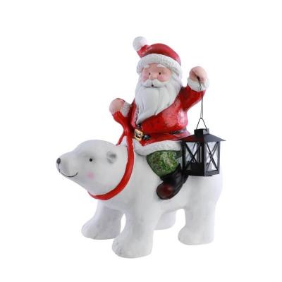 13592 decoration resine pere noel avec lanterne metal sur ours blanc